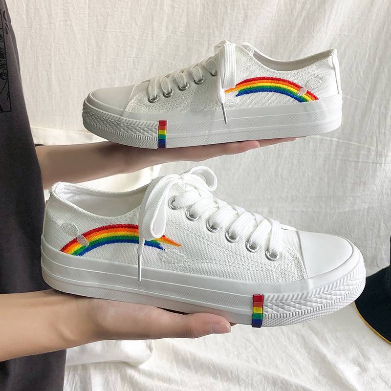 white classical low top converse style sneakers with a rainbow decoration in rainbow aesthetics fashion
