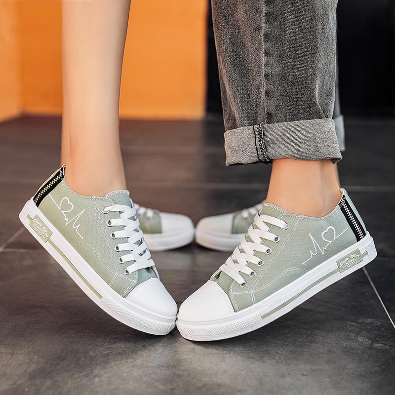 Mint green low top Retro sneakers with embroidered heartbeat pulse