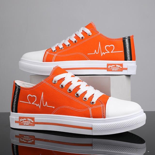 Orange low top Retro sneakers with embroidered heartbeat pulse