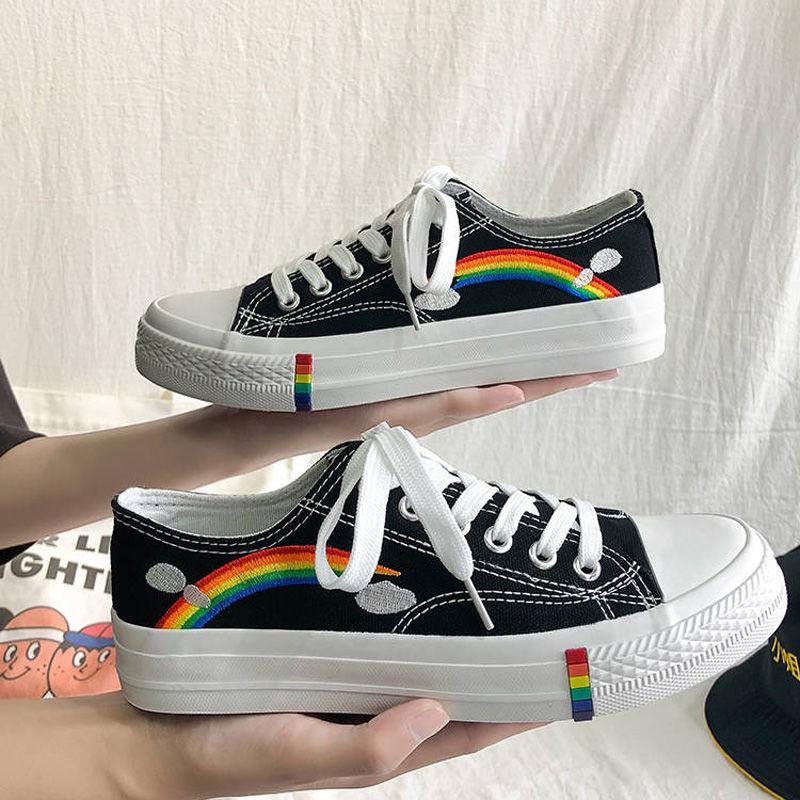 black classical low top converse style sneakers with a rainbow decoration in rainbow aesthetics fashion