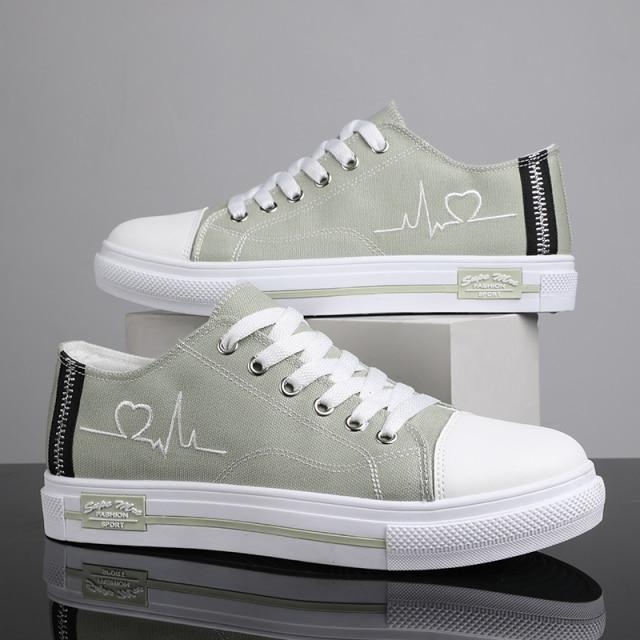 Mint green low top Retro sneakers with embroidered heartbeat pulse